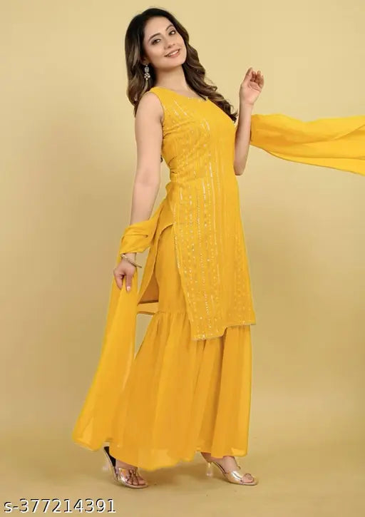 Yellow kameez with sequin work, embellished with embroidery, worn by a woman standing against a yellow background