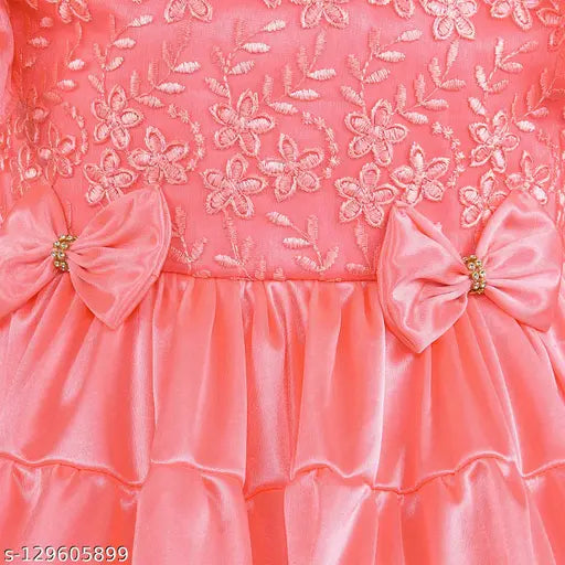Pink satin dress with silver bow, lace trim, and ruffled sleeves