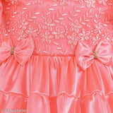 Pink satin dress with silver bow, lace trim, and ruffled sleeves