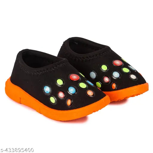 Brightly colored shoes with a pattern of circular color shapes, likely neon or pastel colors, designed for babies