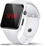 The digital watch in the image is a black and white Apple Watch. It has a rectangular face with a time display reading '12:00'. The band appears to be made of a soft, flexible material, likely a type of silicone or rubber. The watch's design suggests it may have a touch interface for interacting with the device