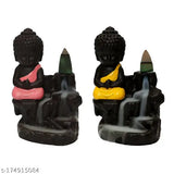 Colorful stone monk statue with a smoke fountain, sitting on a base holding sticks