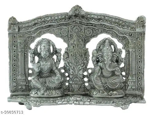 Silver metal statue of Lord Ganesh and Lord Laxmi in ornate decorative frame with Hindu deity motif for puja showpiece
