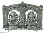 Silver metal statue of Lord Ganesh and Lord Laxmi in ornate decorative frame with Hindu deity motif for puja showpiece