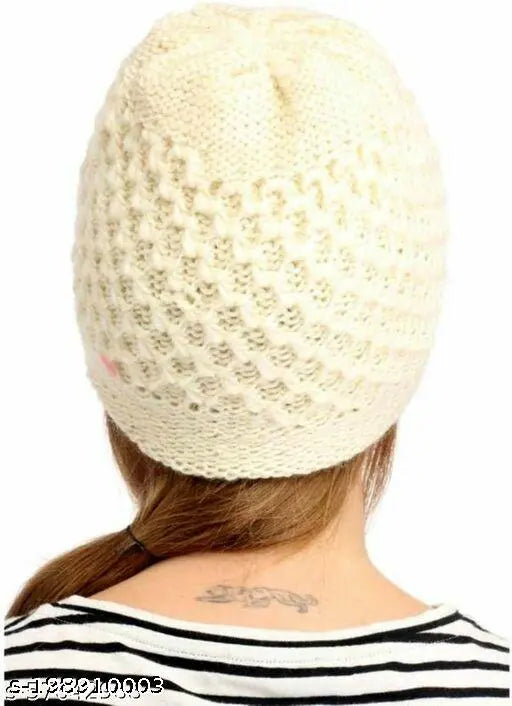 A knitted, cream-colored beanie cap for women