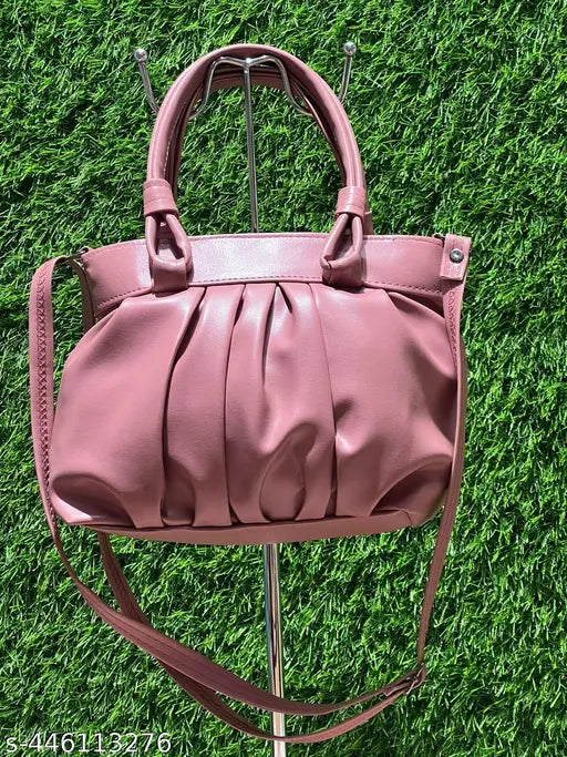 Purple leather sling bag with a quilted design and a large circular handbag