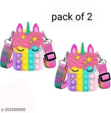 The image shows a pair of cute, multicolored faux leather purses with rainbow unicorn motifs, each featuring a whimsical pink unicorn face on a clear strap and a shiny golden coin purse lining. They are designed in the style of Popit bags, which pop open to reveal a hidden pocket inside. The purses come in two colors: one with pink and blue unicorn patterns, the other with purple and blue
