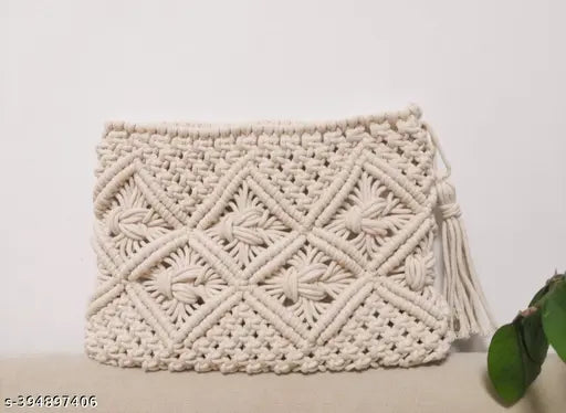 Handwoven boho style beige clutch bag with tassel, perfect for beach or versatile fashion accessory
