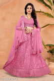 Embroidered Pista-colored net lehenga, choli, and dupatta with zari and dori work, Indian wedding attire on display