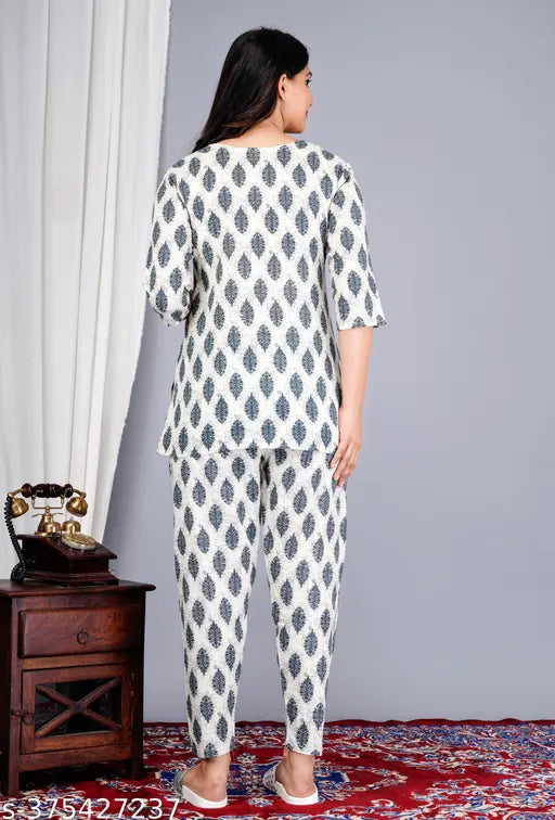 White cotton printed night suit top and pyjama coord set with floral all-over print, 3/4 sleeves, and notch neck, available in sizes M, L, XL, XXL from KIYA FASHION. Comfortable sleepwear designed for quality and function