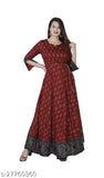 Red and maroon Indian dress with flared sleeves, fitted waist, and long skirt