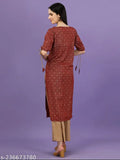 Maroon rayon kurta and palazzo set with all-over gold print, keyhole neck, three-quarter sleeves, tie-up and tassels. Made in India