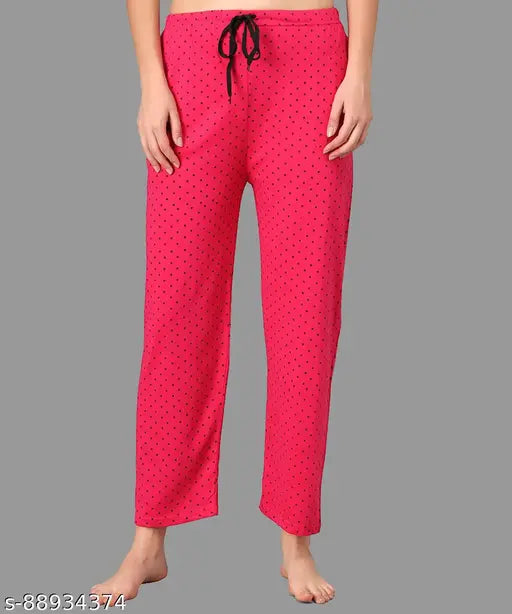 The image displays a pair of Anixa print pyjama pants in night wear style. These pants are designed with a drawstring waistband and feature a vibrant polka dot pattern on red cotton fabric. They appear to be in size small, medium or large as indicated by the sizing chart provided in the image. The pants are presented in a set of two, suitable for girls' or women's night wear needs