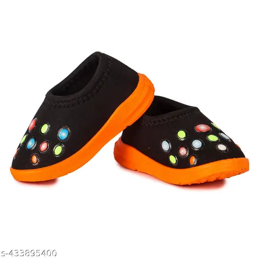 Black and orange shoe with multi colored dots, possibly neoprene or rubber material