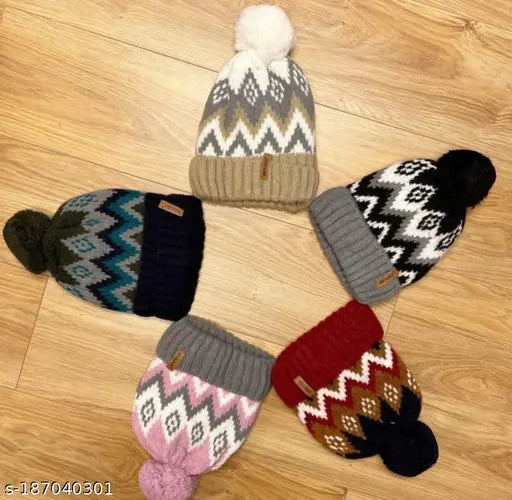 Black, gray, blue, and pink knit beanie hats with faux fur pompoms