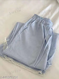 Light blue denim shorts with rolled up legs and lace trim on bottom