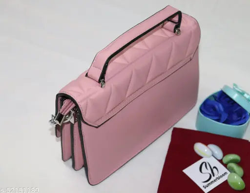 Pink sling bag with removable strap and hand handle