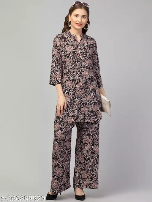 Black multi-printed rayon top with palazzo set for women, features three-quarter sleeves and soft, lightweight fabric. Perfect for various occasions, machine washable, made in India