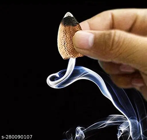 Black and white glass incense holder with a single, lit stick of adiyogi ji incense