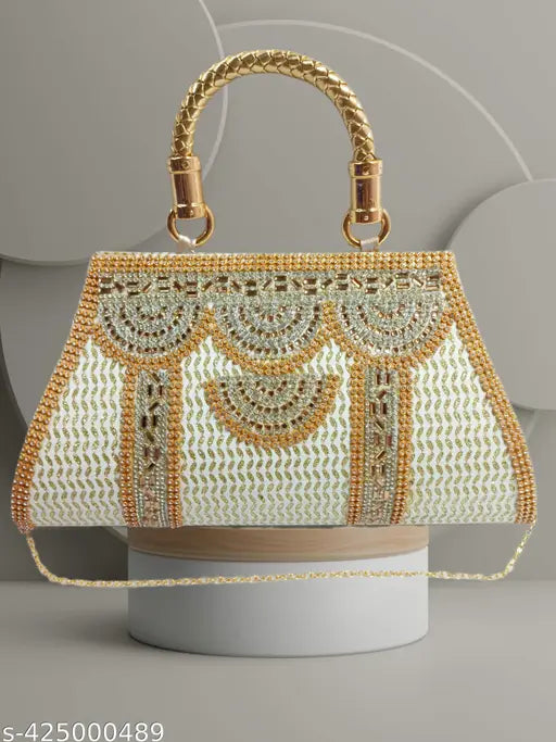 A gold embellished white purse with a beaded chain strap