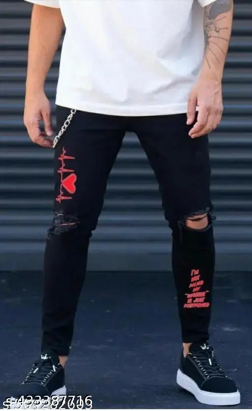 Black denim jeans with red heart graphic and rips on knees