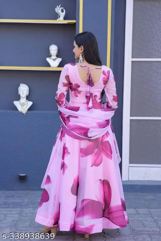 Pink and white patterned sari, choli with blouse, woman standing against wall
