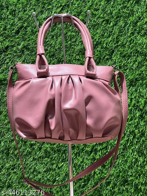 A pink quilted leather shoulder bag with zip closure