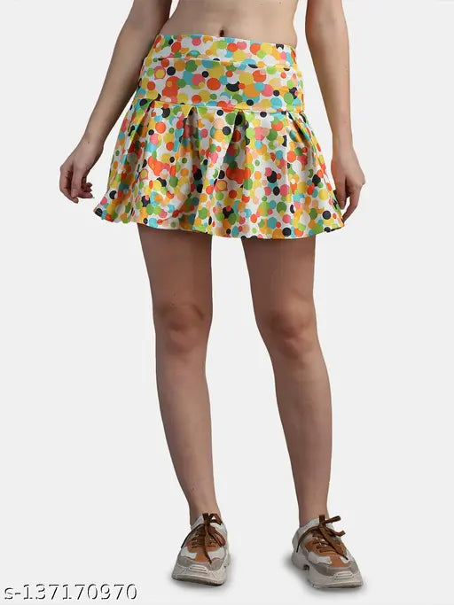 Polyester N-Gal dots printed mini skirt with attached inner shorts, multi-colored skater style for versatile dressing options. Elastic waistband and pleated design ideal for everyday wear or casual outings. Available sizes: 28, 30, 32, 34, 36 (waist: 28in - 34in, length: 16in - 18in, hip: 36in - 42in). Made in India