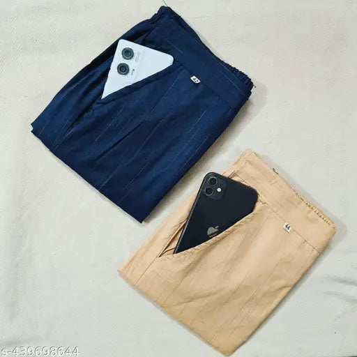 Beige cotton trousers, with black phone in front pocket