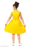 This is a photo of an individual wearing a yellow, knee-length dress with puff sleeves. The dress has ruffled detailing along the waistline. The person is also wearing black shoes and has short hair