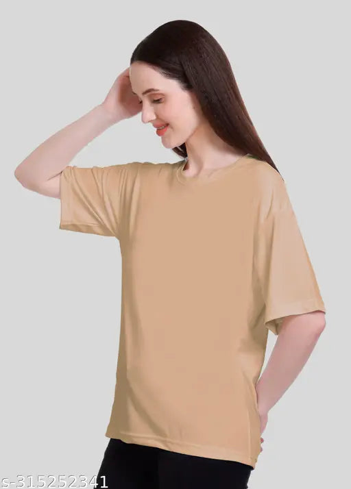 The image displays a woman wearing a tan t-shirt with dropped shoulders and short sleeves