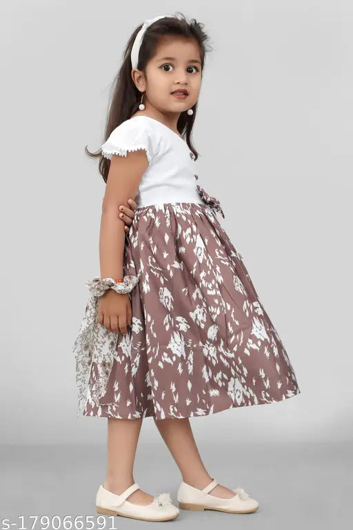 Little girl in a floral belted dress with ruffle trim