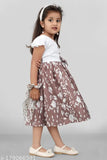 Little girl in a floral belted dress with ruffle trim