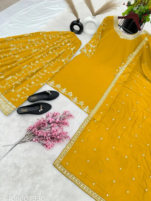 Yellow georgette top with detailed embroidery and embellishments, paired with sharara bottom