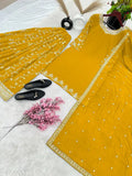 Yellow georgette top with detailed embroidery and embellishments, paired with sharara bottom
