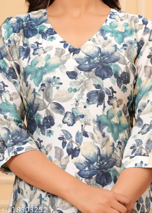 Women's floral printed muslin fabric kurta with trousers, kora muslin and regular beads & stones, three-quarter sleeves set on Indian backdrop