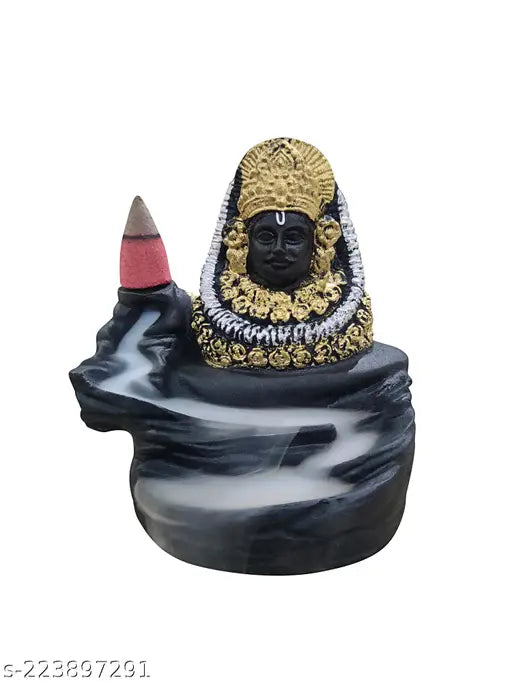 This is an image of a decorative incense holder with the statue of Lord Shyam and 10 cones of incense. It has a shiny, golden finish. The holder features a figure at the bottom with a stick of incense on it. The item appears to be made of metal and is adorned with gold accents. The backflow cone design suggests that the holder is intended for use with specific types of incense cones