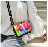 A colorful, fabric sling with a vibrant print, designed as a fashionable crossbody bag, ideal for casual outings