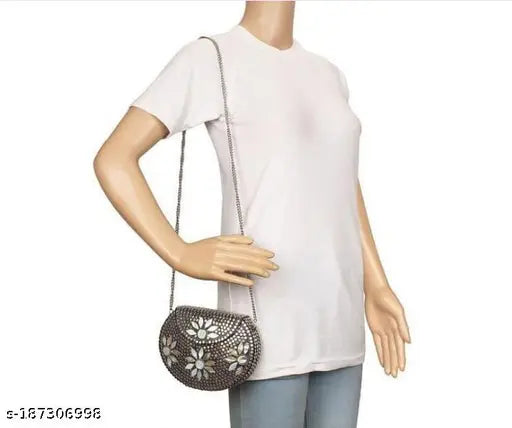 Women's white crop top with embellished shoulder strap and a small handbag