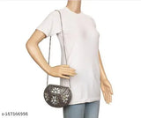 Women's white crop top with embellished shoulder strap and a small handbag