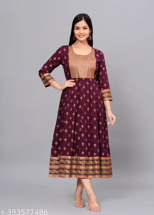 A woman is wearing a long, printed Anarkali Kurta in wine or maroon color