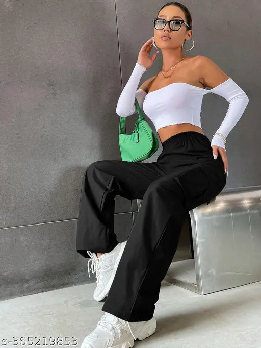 Black high-waisted trousers with white tank top and sunglasses