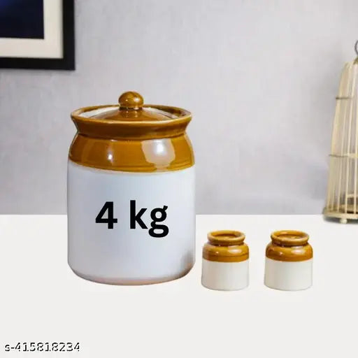 This is an image of a ceramic achaar jar, with text that reads "4kg" and "4000ml." The jar appears to be designed for pickles or other preserved food items. It has a lid and is placed next to two smaller salt containers and a larger pepper shaker