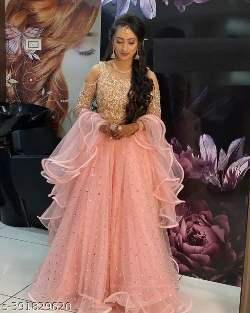 Orange sequence velvet lehenga-choli with embellished net dupatta, floral print topwear and embellished net bottomwear on model