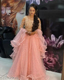 Orange sequence velvet lehenga-choli with embellished net dupatta, floral print topwear and embellished net bottomwear on model