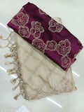 Designer saree with floral pattern and fringe ends, maroon background