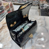 Black leather sling with chain straps, women's fashion accessory
