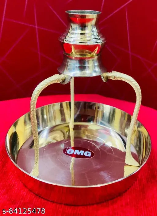 Shiny brass temple lamp with a red glass bulb, metal stand