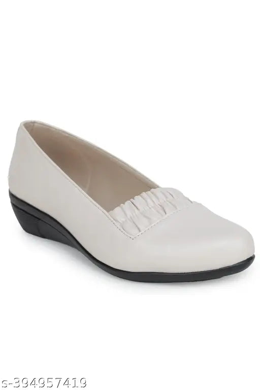 White flat shoes with pointed toes and flared heels