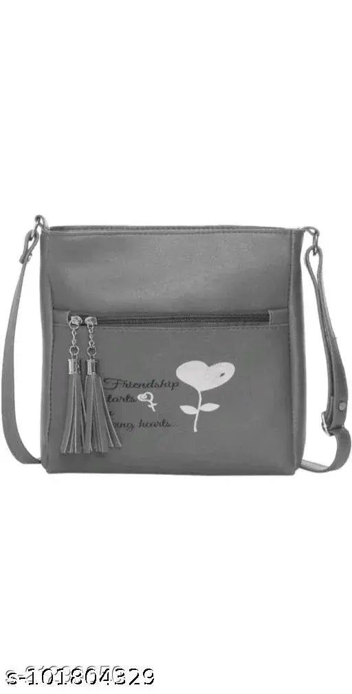 Black leather slingbag with keychain and heart design, 1 main compartment